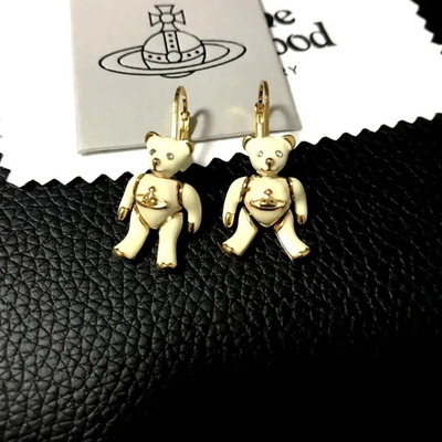 Vivienne Westwood earrings, gold beige, eye stones, movable limbs, box included