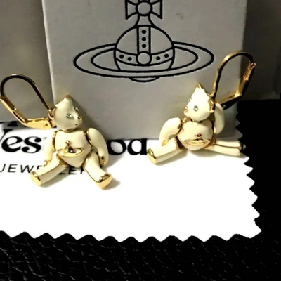 Vivienne Westwood earrings, gold beige, eye stones, movable limbs, box included