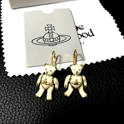 Vivienne Westwood earrings, gold beige, eye stones, movable limbs, box included